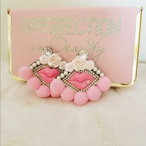 Pink lip with pink pom pom earrings